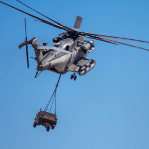 Helicopter carrying military humvee